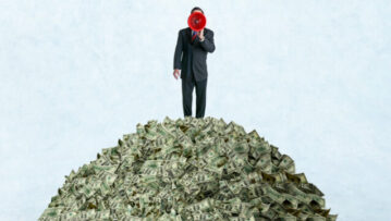 A businessman shouts through a red megaphone as he stands on top of a pile of money.